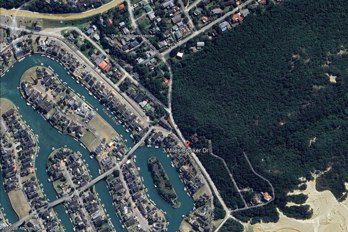 An aerial view of the residential area and surrounding landscape, highlighting the property location and proximity to the canal and coastal forest.
