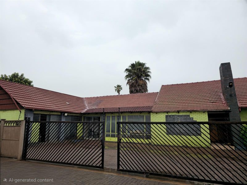 Exterior view of a single-story house featuring a tiled roof, brick facade, and a metal security gate entrance.