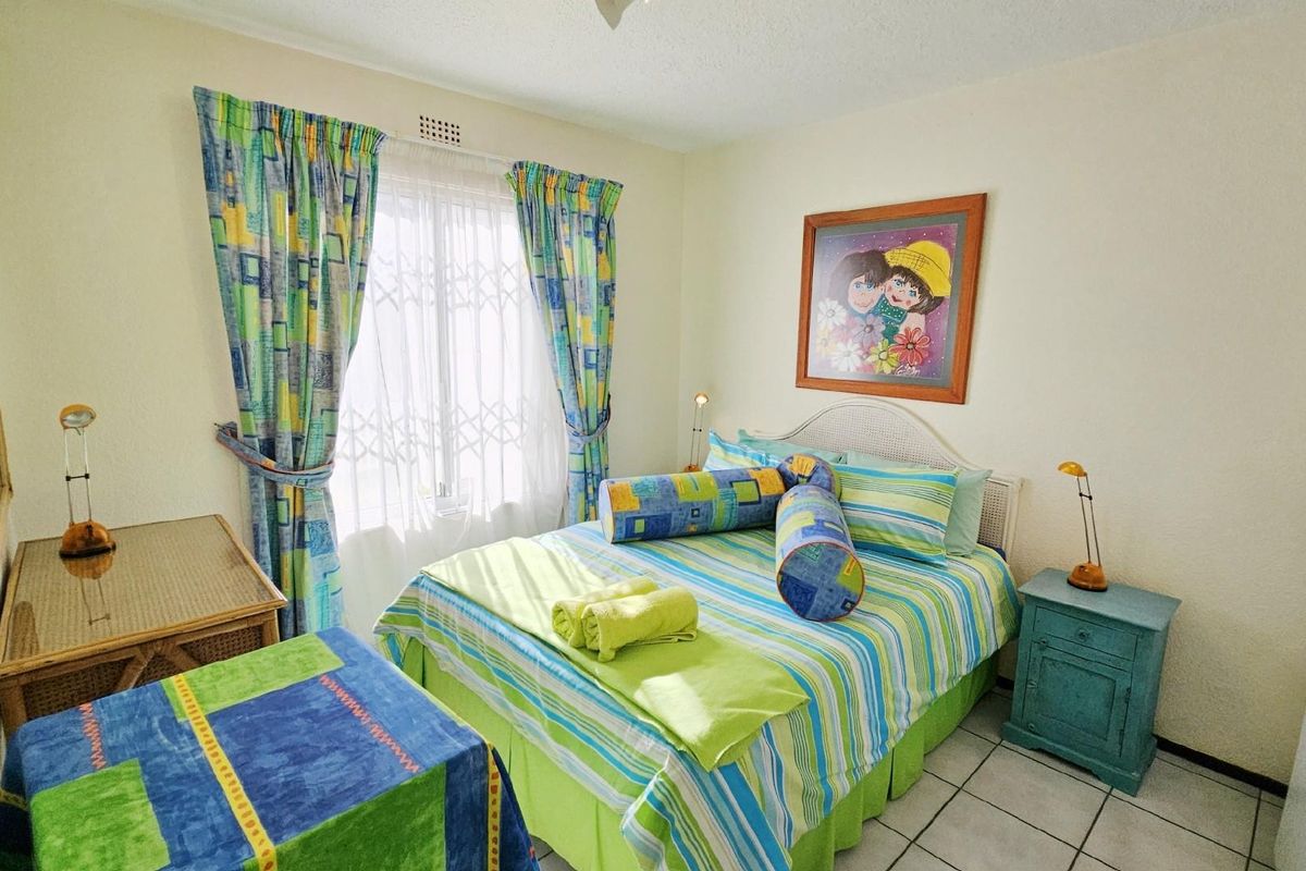 A bedroom featuring tiled flooring, a window with security gate, and a ceiling vent.