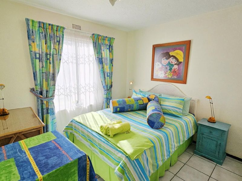 A bedroom featuring tiled flooring, a window with security gate, and a ceiling vent.