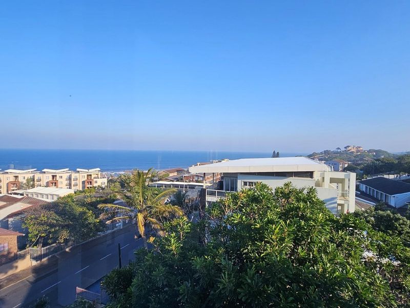 A scenic elevated view overlooking the surrounding residential neighbourhood and the distant coastline.