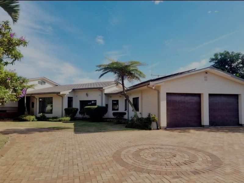 A well-maintained single-story residence featuring a paved driveway, double garage, and established garden frontage.