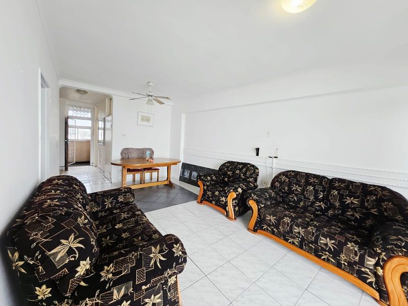 Open plan living and dining area featuring white tiled flooring, ceiling fan, and access to an adjacent balcony area.