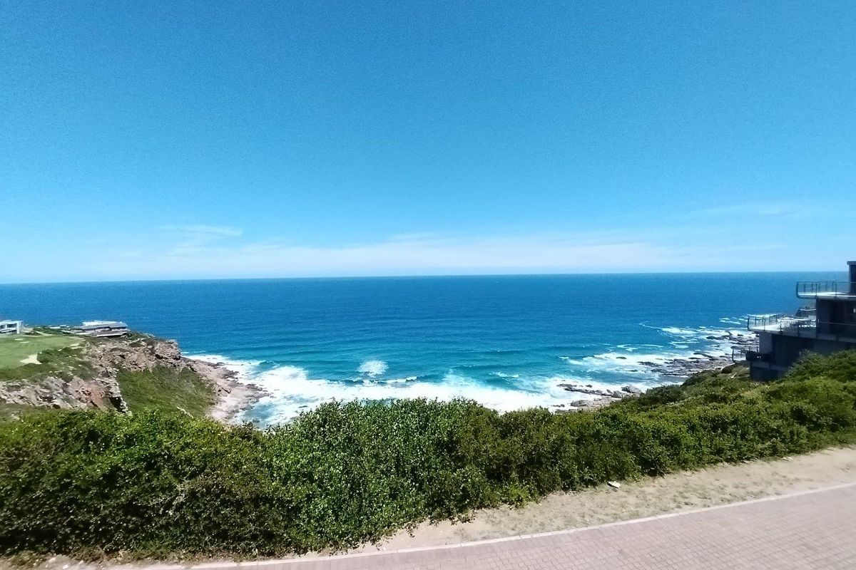 A stunning elevated coastal view overlooking the ocean, rocky shoreline, and surrounding natural landscape from the property.