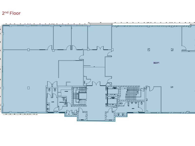 Architectural floor plan for the second floor of the office building, detailing the layout of office spaces, stairwells, elevators, and restroom facilities.