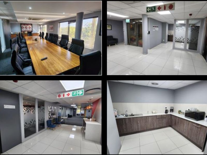 A professional office suite featuring a boardroom, reception area, and a functional kitchenette with modern cabinetry and tiled flooring.