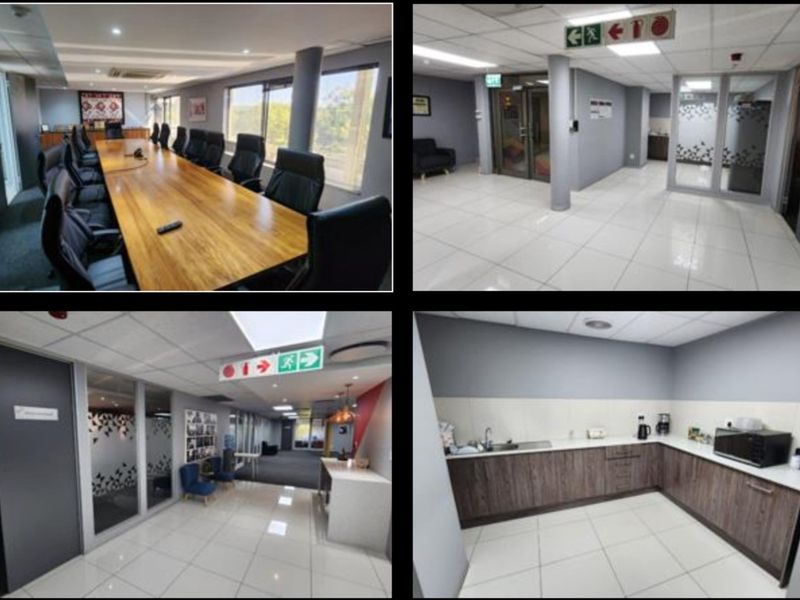 Professional office suite featuring a boardroom, open-plan workspace, glass-partitioned offices, and a functional kitchenette with modern cabinetry and tiled flooring.