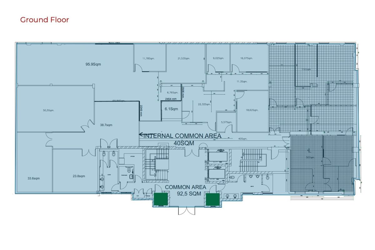 Ground floor architectural layout plan showing office spaces, common areas, staircases, and elevator access points.