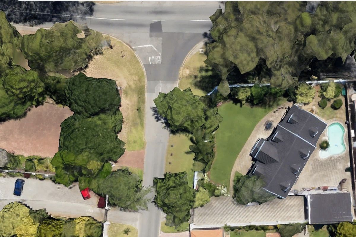 Aerial view of the commercial property showing the building, surrounding landscaped grounds, swimming pool, and access driveway from the street.