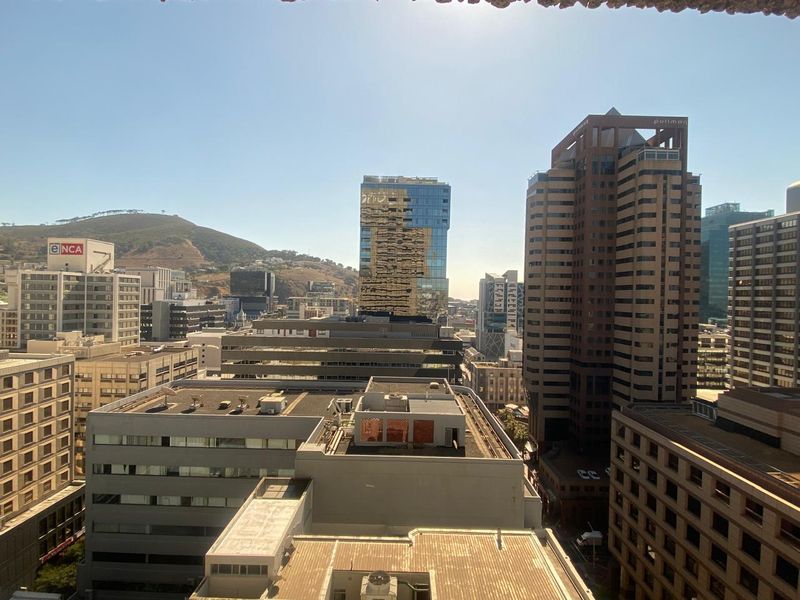 An elevated city skyline view showcasing surrounding commercial office buildings and urban architecture.