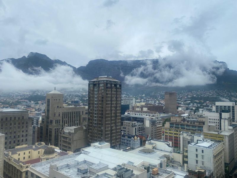 Elevated panoramic city view overlooking the urban skyline with Table Mountain in the background.