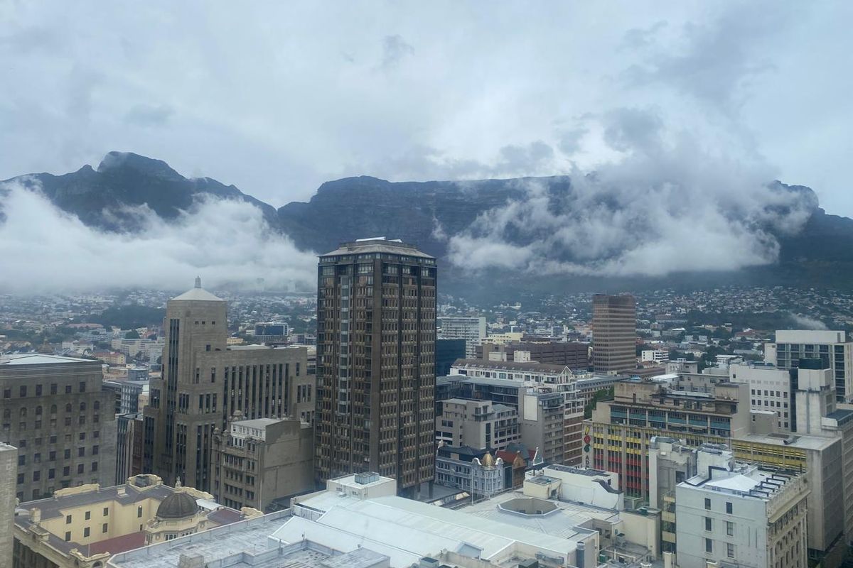 Elevated panoramic city view overlooking the urban skyline with Table Mountain in the background.