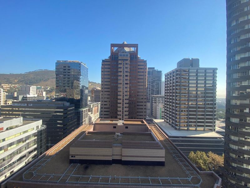 An elevated city skyline view showcasing surrounding high-rise office buildings and urban architecture.