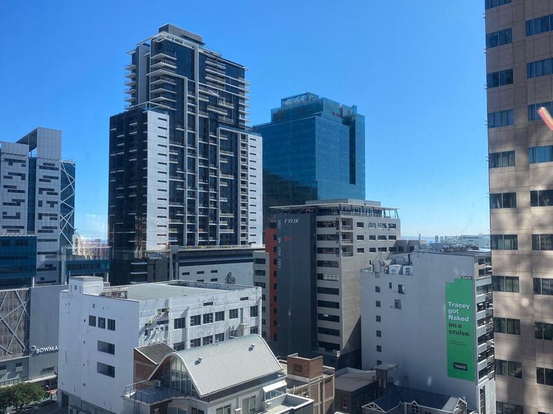 An elevated city view showcasing surrounding high-rise office buildings and urban architecture in a dense metropolitan area.
