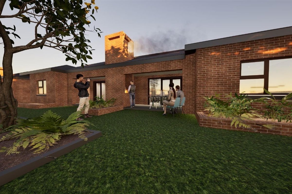A rear view of a brick townhouse featuring a covered patio area, a built-in brick chimney, and a landscaped garden.