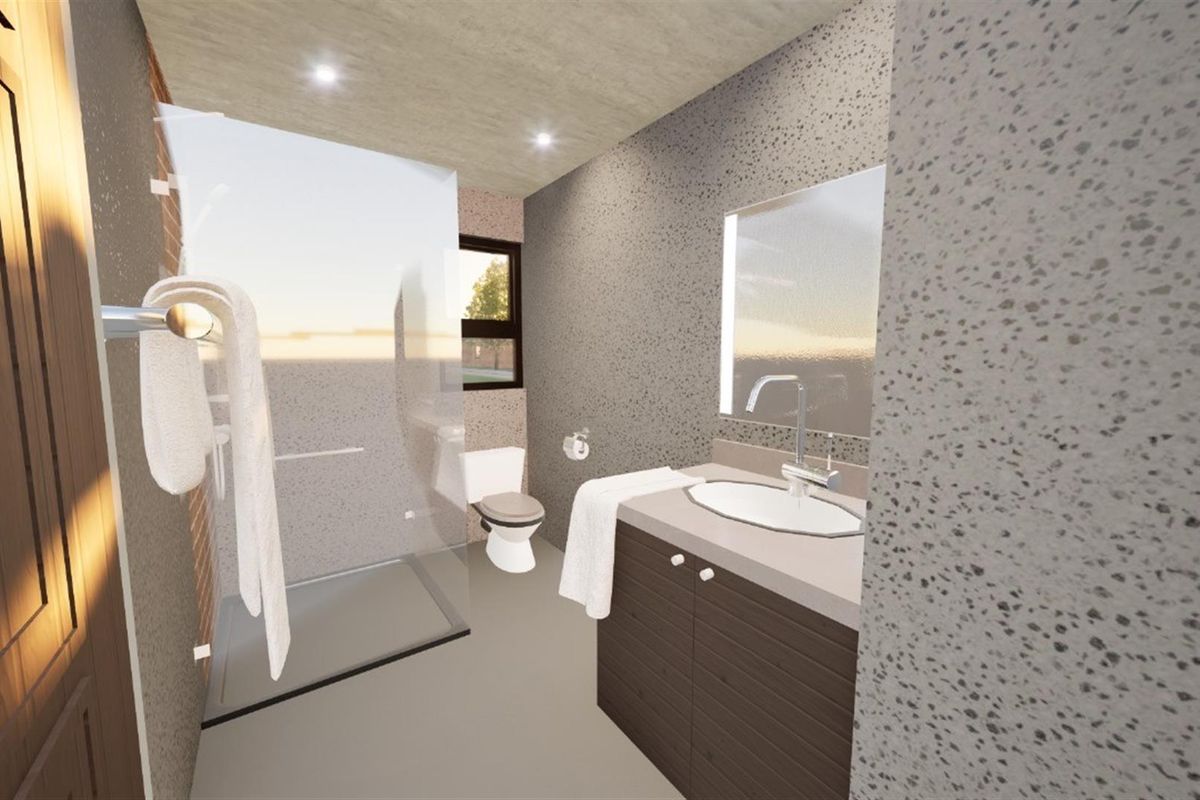 Modern bathroom featuring a glass-enclosed shower, vanity with integrated basin, and contemporary speckled wall finishes.