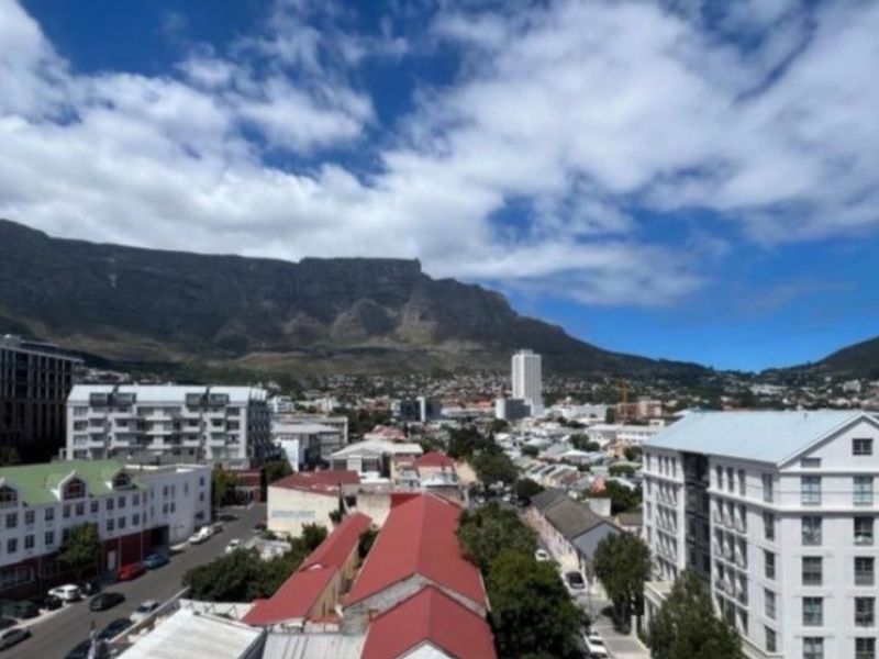 An elevated panoramic view of the surrounding urban landscape and mountain range, showcasing the property's prime location and scenic outlook.