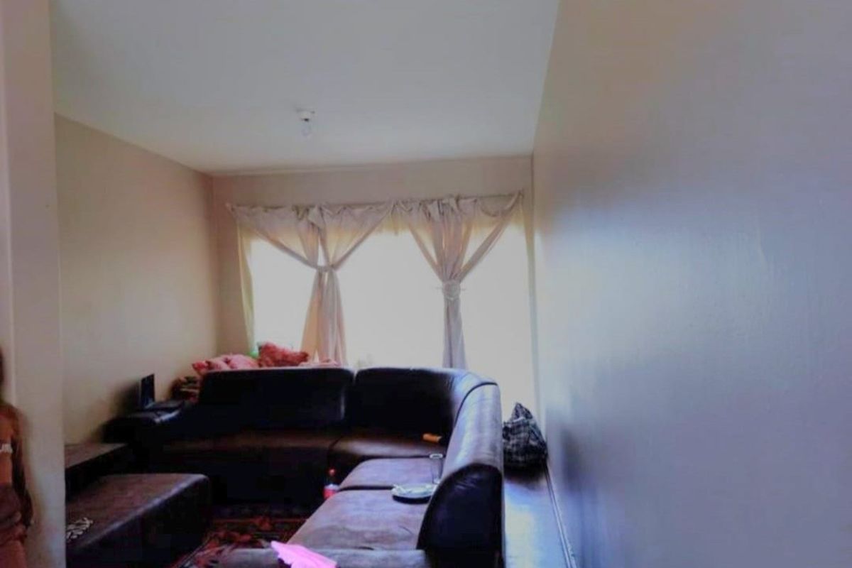 A living room area featuring a large window that provides natural light to the space.