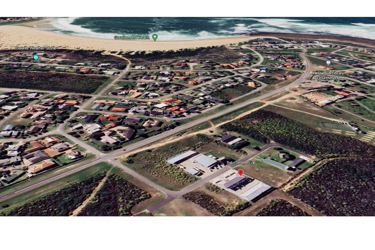 Aerial view of the commercial property located in Gouritsmond, showcasing its proximity to the coastline and surrounding residential area.