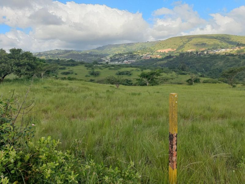 Expansive view of the surrounding landscape and rolling hills, showcasing the natural terrain and open space of the property.