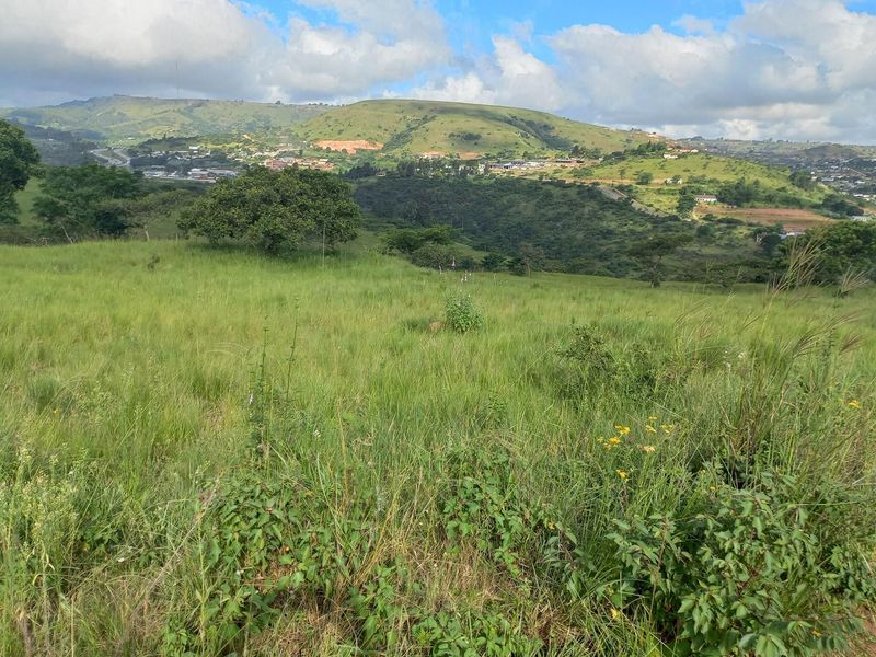 Expansive view of rolling green hills and natural landscape, showcasing the scenic outlook from the property.