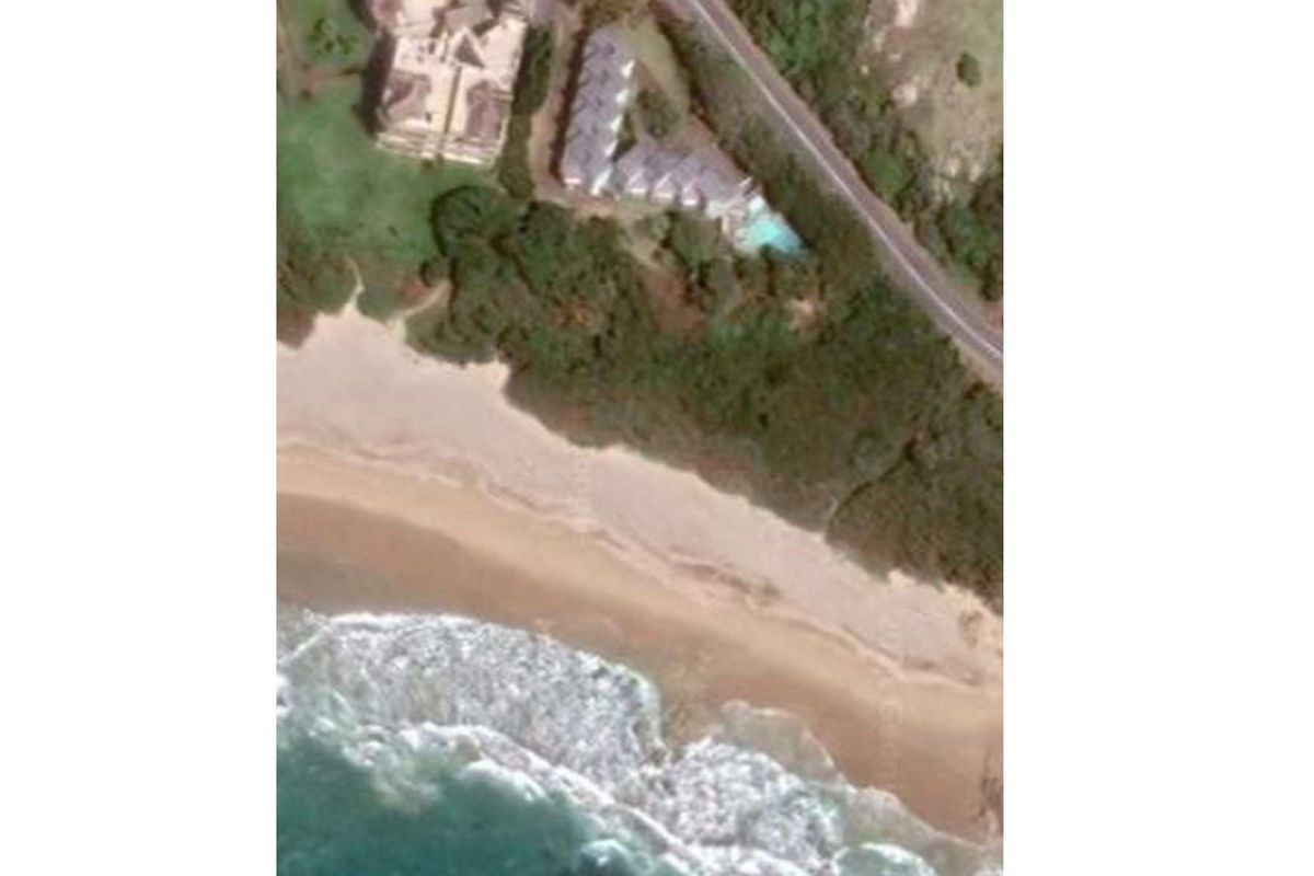 Aerial view of the commercial property showing its proximity to the coastline and beach access.