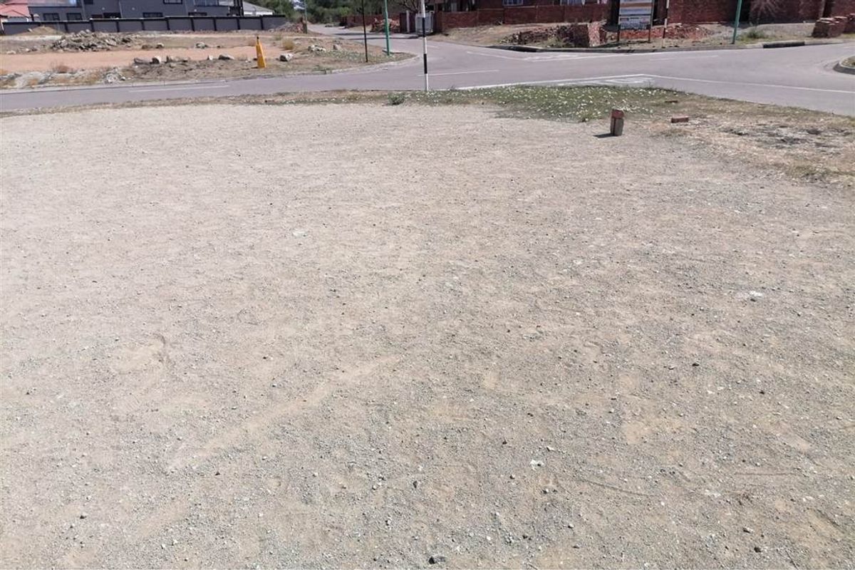 A vacant residential corner plot featuring level ground, ready for development in a established neighborhood setting.