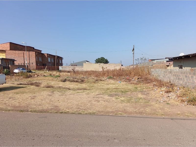 A vacant residential plot featuring boundary walls and direct street access, ready for development.