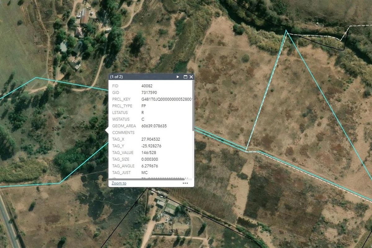 Aerial view of vacant residential land showing property boundaries and surrounding landscape.