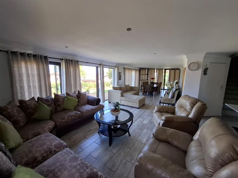 Spacious open-plan living and dining area featuring large sliding glass doors that provide abundant natural light and seamless access to the outdoor space.