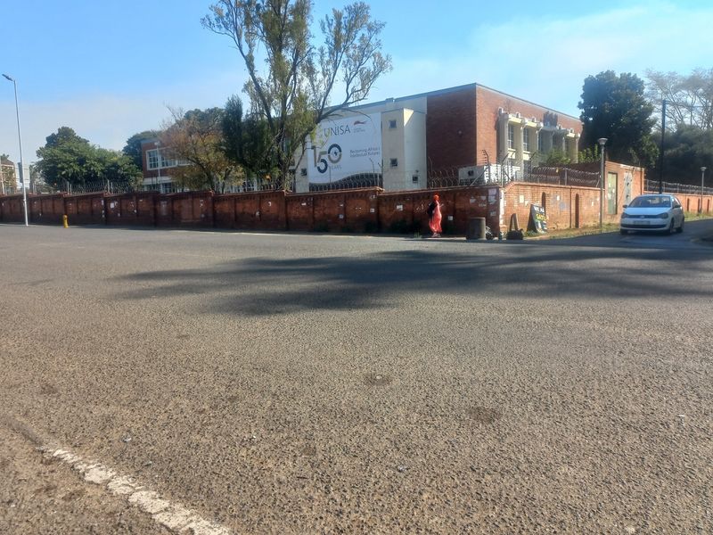 Street view showing the exterior perimeter wall and fencing of the property.