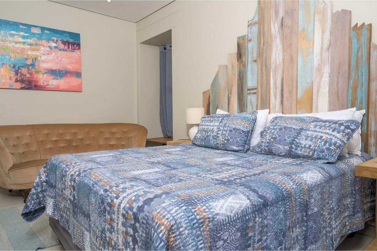 A well-maintained bedroom featuring neutral wall finishes and a recessed alcove area.
