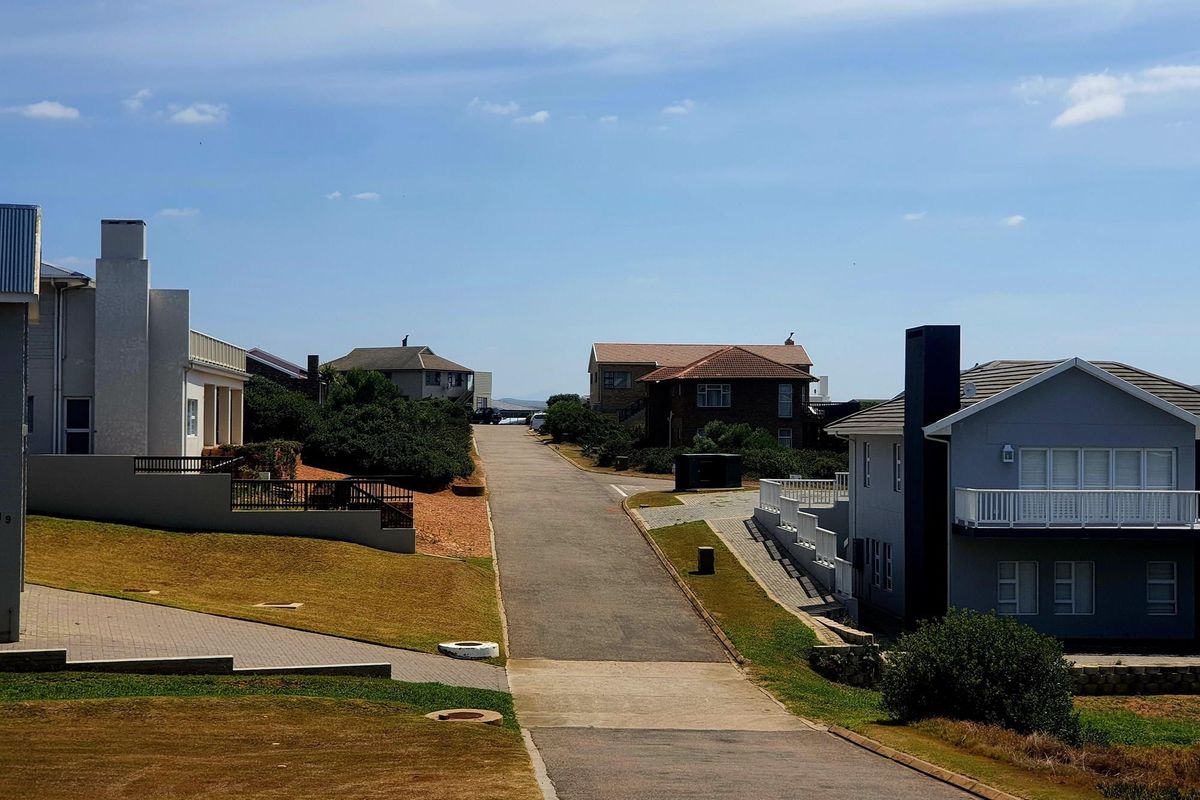 A view of the residential street and surrounding neighborhood, showcasing the established road infrastructure and neighboring properties.
