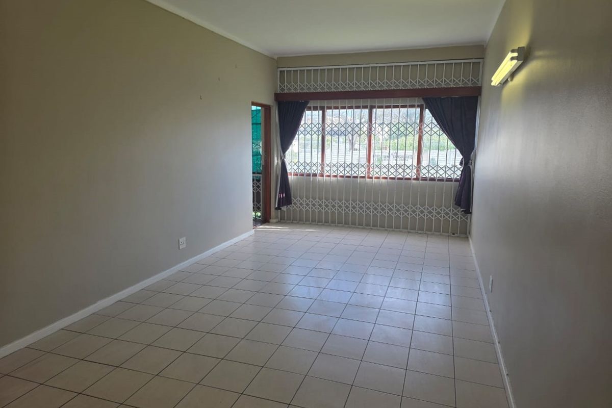 Ground-floor 3-bed apartment with closets, separate kitchen, veranda, and full burglar bars. - Photo 2