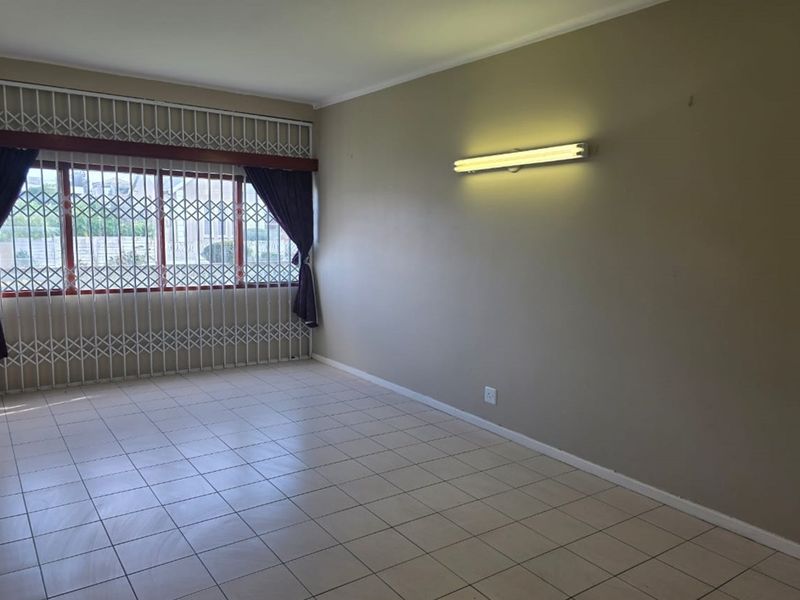 Ground-floor 3-bed apartment with closets, separate kitchen, veranda, and full burglar bars. - Photo 3