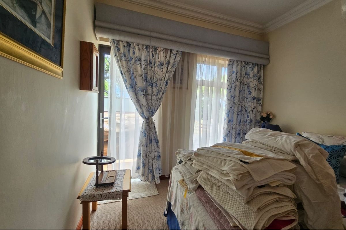 A bedroom featuring carpeted flooring and a sliding glass door providing access to the exterior.