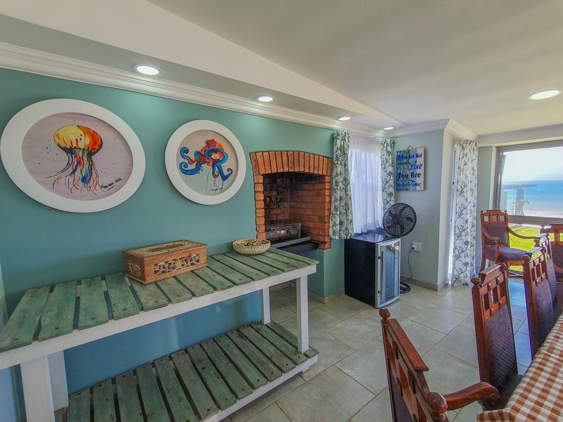 Living area featuring a built-in brick fireplace, recessed lighting, tiled floors, and direct access to an outdoor view through a sliding glass door.