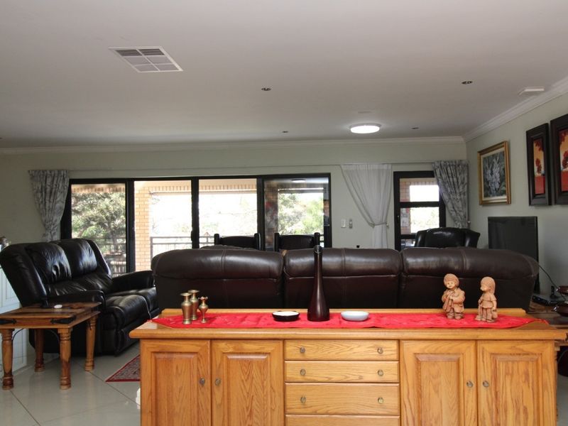 Spacious open-plan living area featuring large sliding glass doors that provide access to the patio and allow for ample natural light.