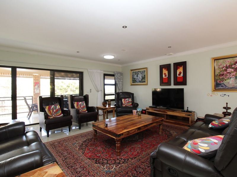 Spacious living room featuring large sliding glass doors that provide seamless access to the outdoor patio area.