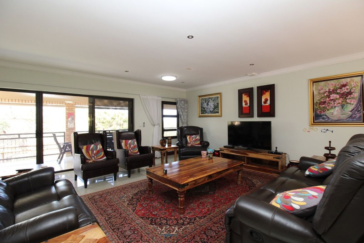 Spacious living room featuring large sliding glass doors that provide seamless access to the outdoor patio area.