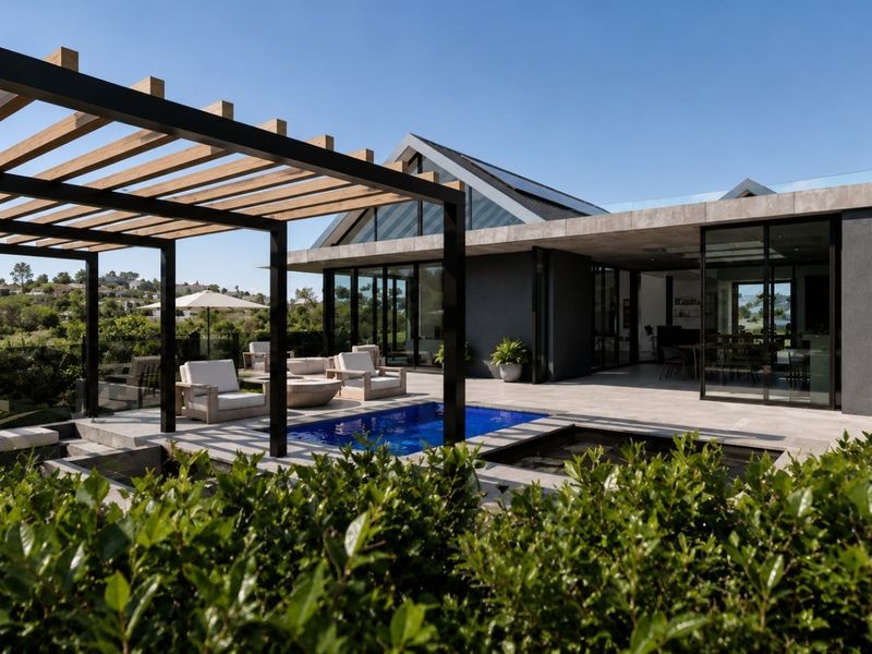 Modern outdoor entertainment area featuring a swimming pool, timber pergola, and expansive tiled patio with seamless indoor-outdoor flow through large glass sliding doors.