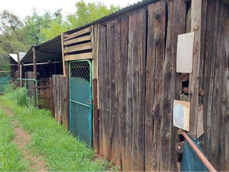 Rustic farm outbuilding featuring weathered timber walls and corrugated metal roofing, suitable for agricultural storage or livestock shelter.