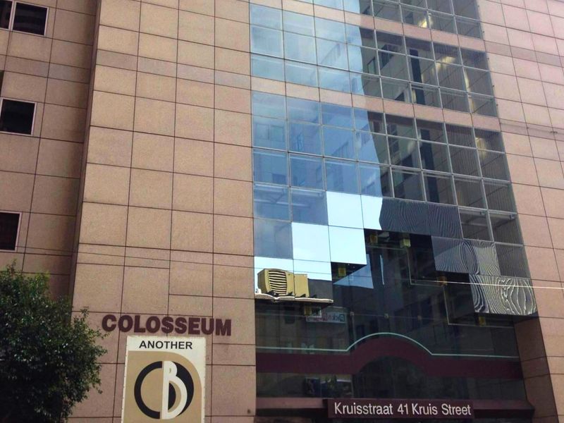 Exterior facade of the Colosseum building at 41 Kruis Street, featuring a modern glass curtain wall and stone cladding.