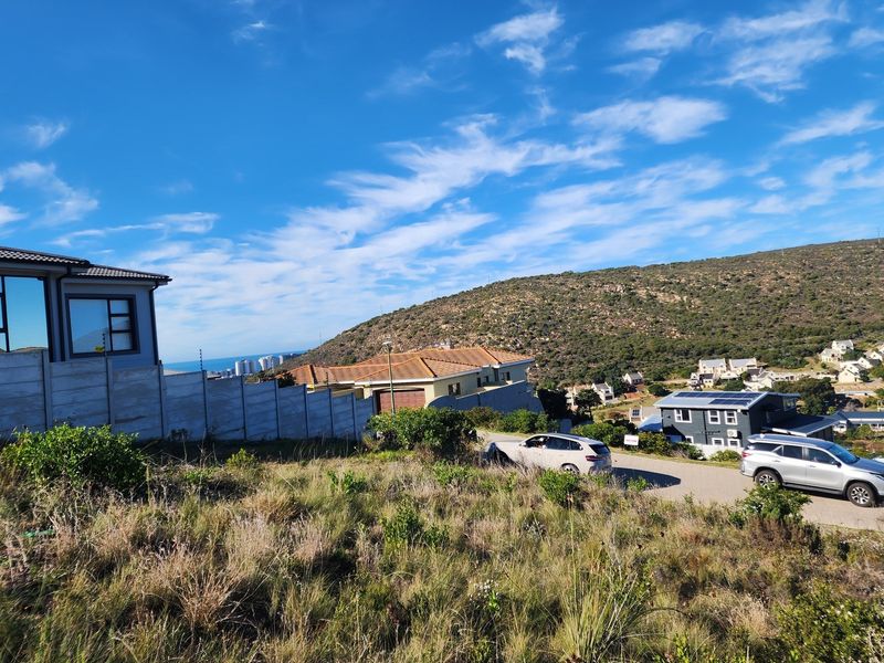 A view of the vacant residential land showing surrounding neighborhood, hillside landscape, and nearby residential properties.