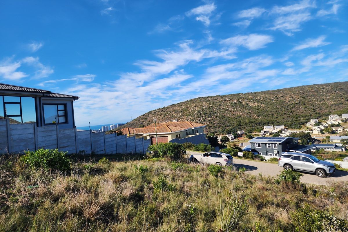 A view of the vacant residential land showing surrounding neighborhood, hillside landscape, and nearby residential properties.