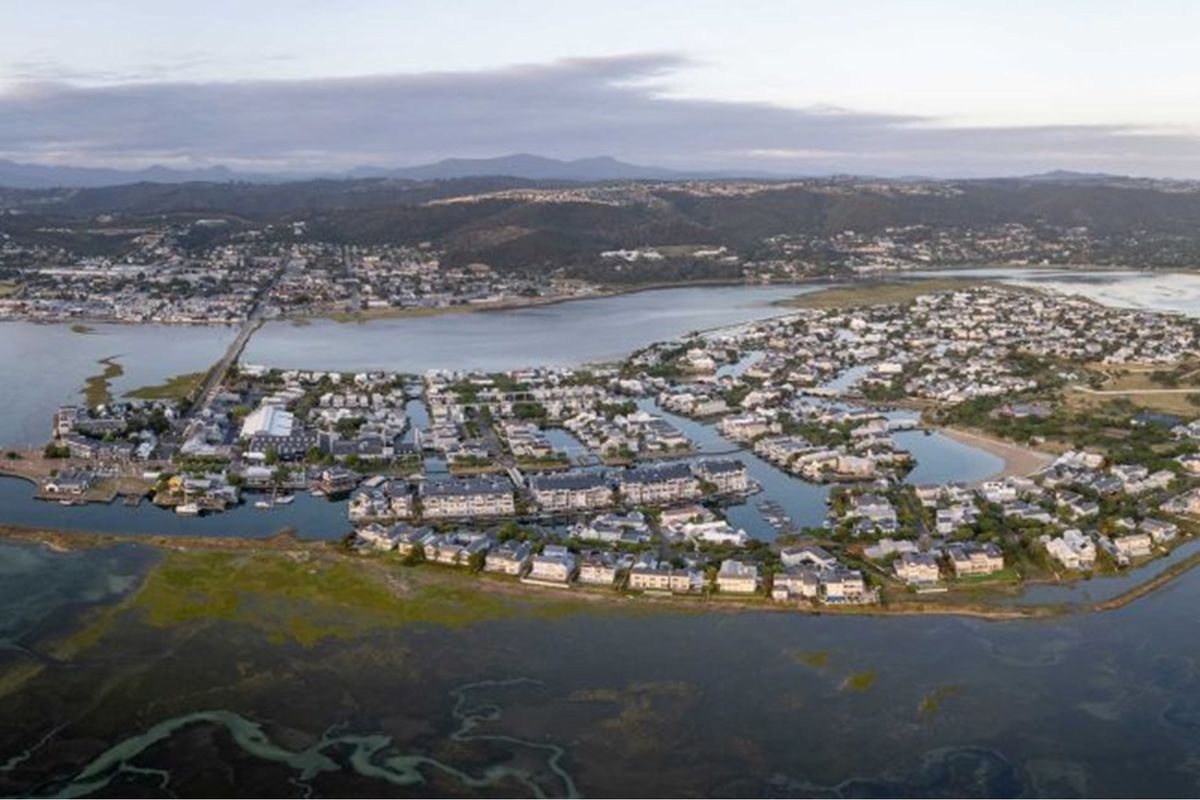 Aerial view of the residential estate and surrounding lagoon landscape, showcasing the property's prime waterfront location and coastal setting.