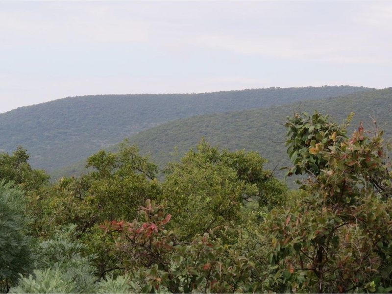 A scenic view of the surrounding natural landscape and rolling hills, showcasing the property's elevated position and tranquil environment.