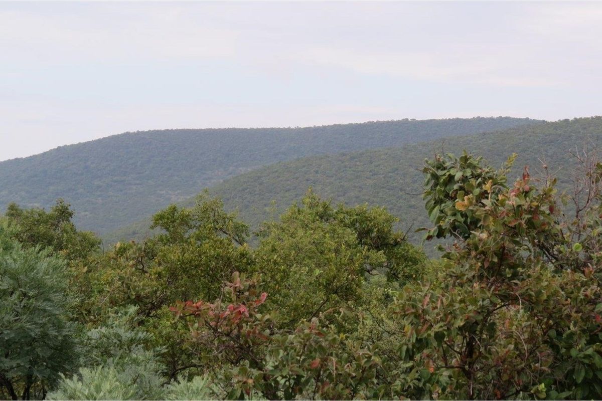 A scenic view of the surrounding natural landscape and rolling hills, showcasing the property's elevated position and tranquil environment.
