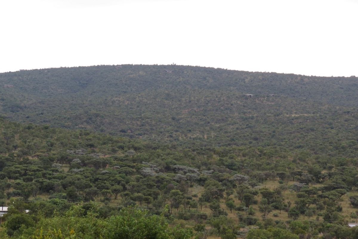 A scenic view of the surrounding natural landscape and rolling hills, showcasing the property's tranquil and elevated position.