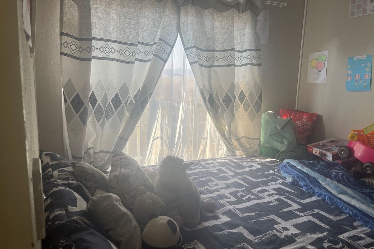 A bedroom featuring a window with natural light, providing a functional space for rest.